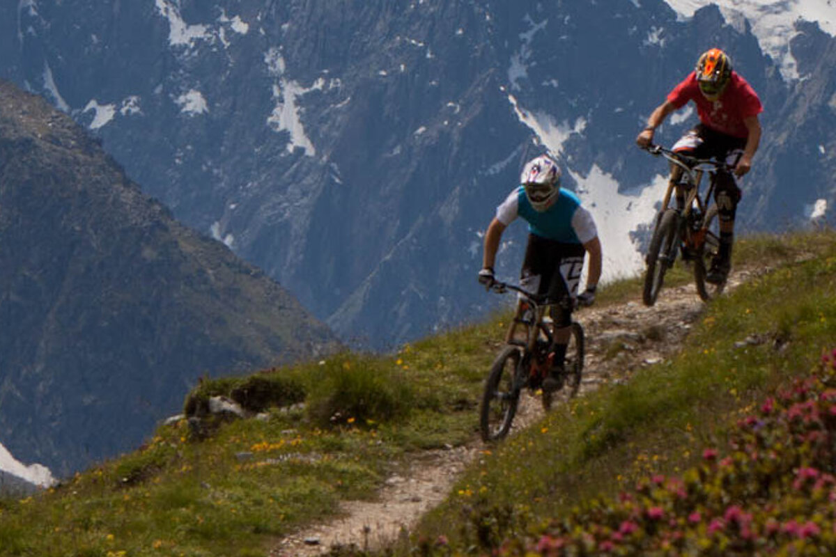 two pro mountain bike riders on a trail