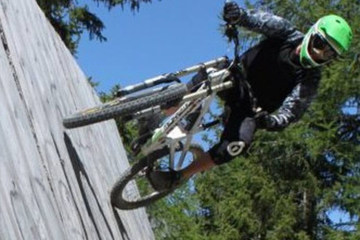 a mountain biker high on a wall ride