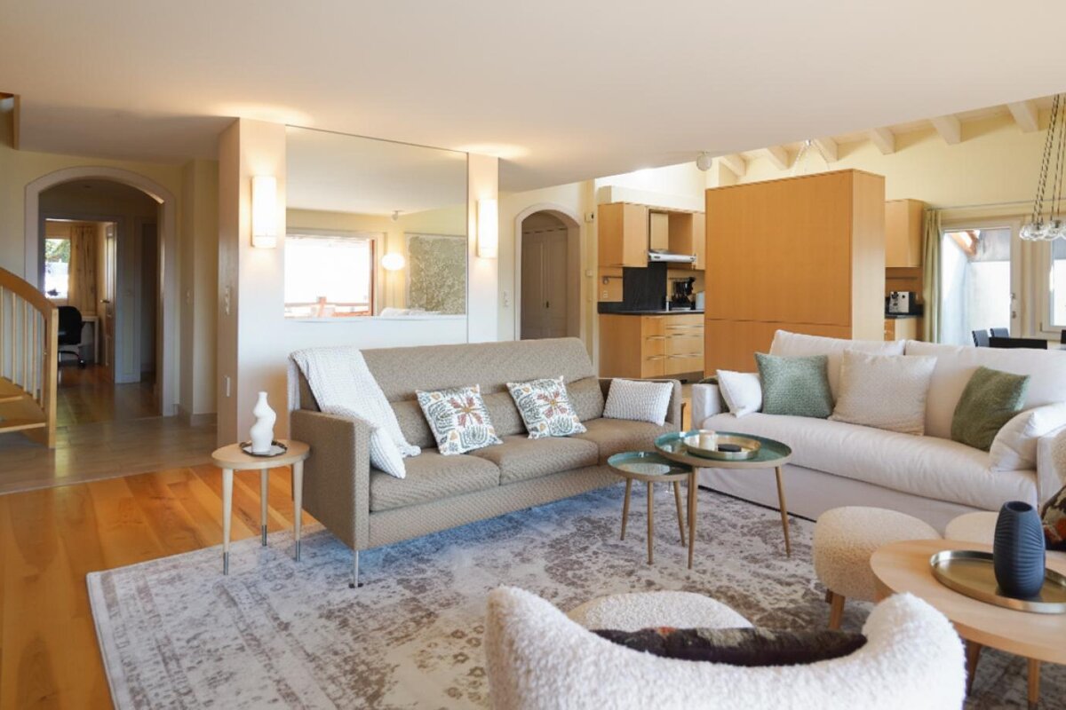 A living room with a couch and two tables