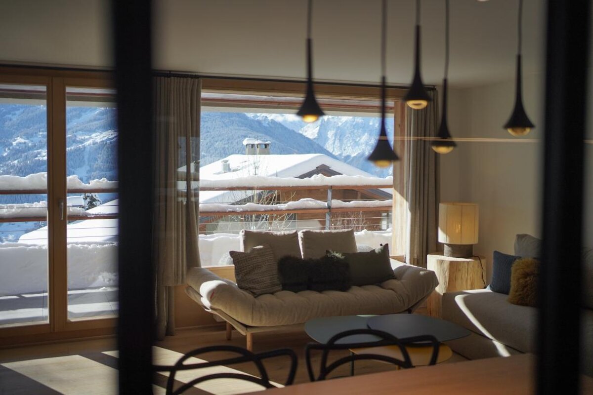 A living room with a view of snow covered mountains