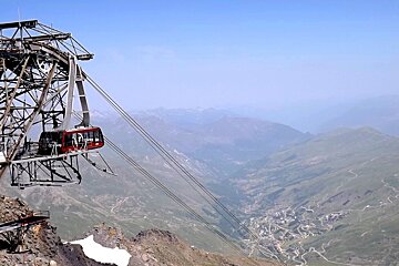 a large gondola at the top of the mountain in summer