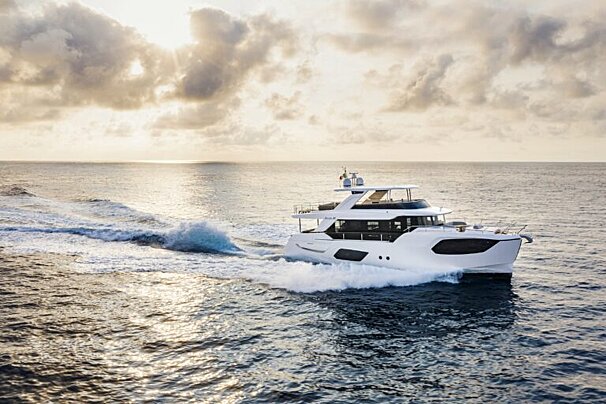 A large white yacht is floating in the ocean