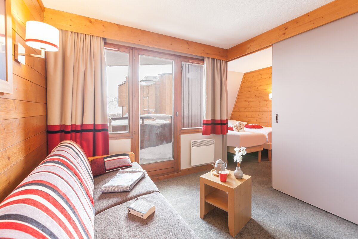 A living room with a couch and a book on it