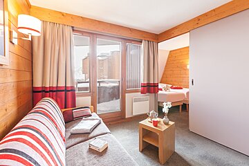 A living room with a couch and a book on it