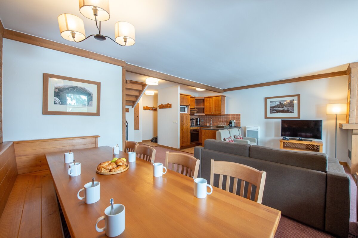 A living room with a dining table and chairs