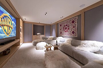 A room with a large screen that says warner bros on it