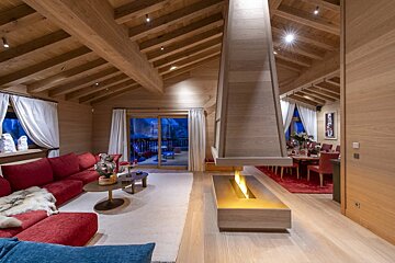 A living room with red furniture and a fireplace