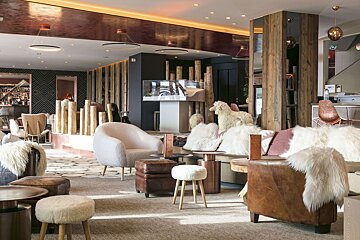 A room with a lot of chairs and stools