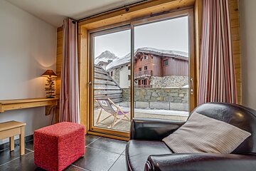 A chair in a room with a sliding glass door