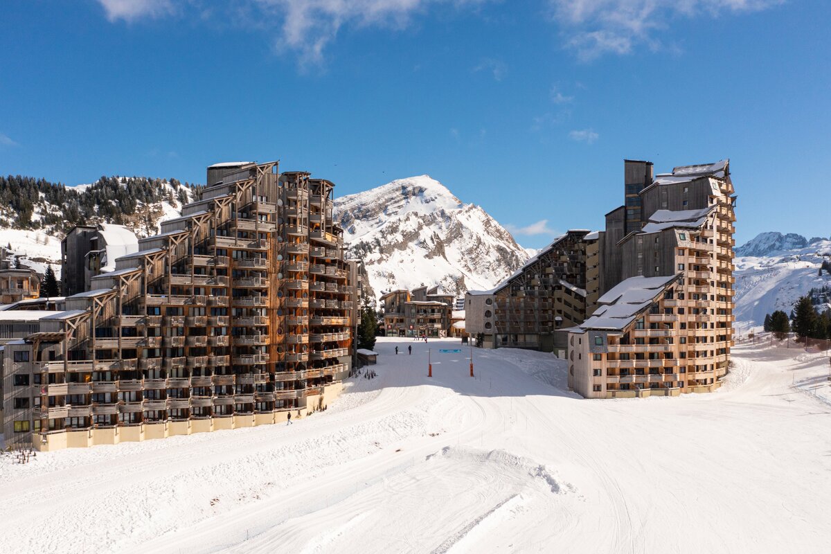 A ski resort with a mountain in the background