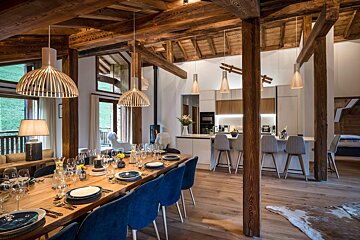 A dining room with a long table and blue chairs