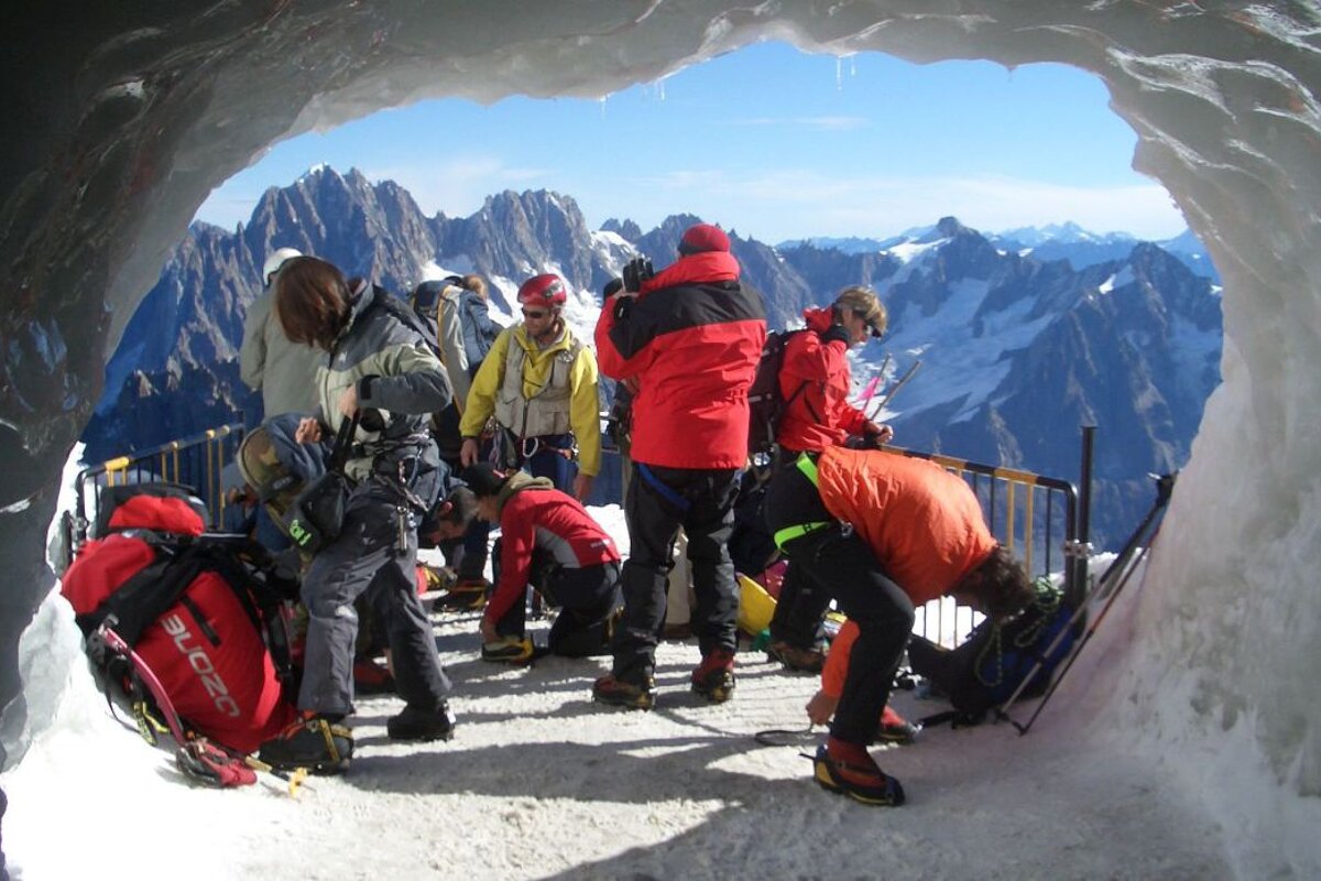 An image of climbers, Alpinists and mountaineers preparing to set off on an expedition from the Aiguille du Midi in Chamonix Mont Blanc