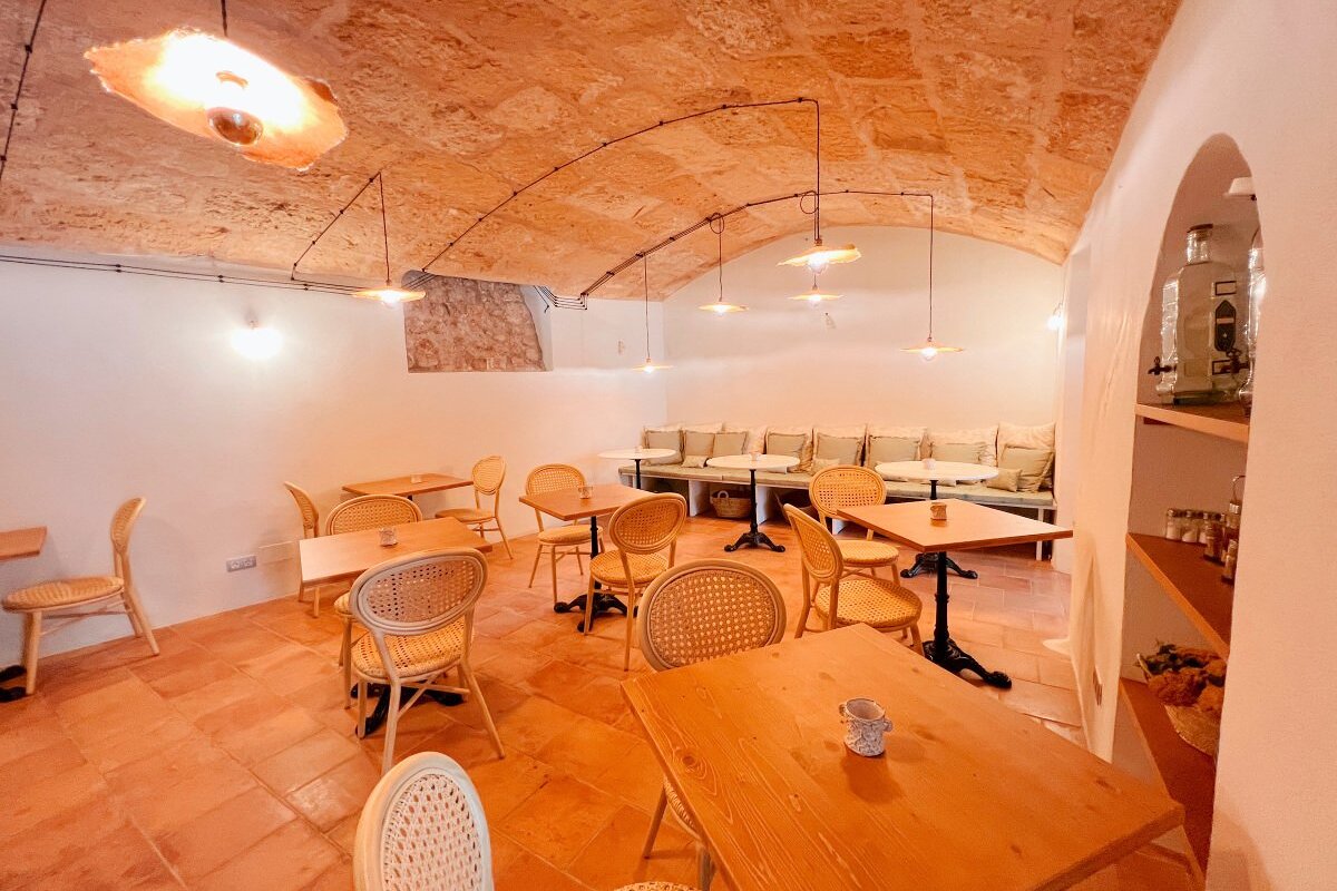 A dining room with tables and chairs and a stone ceiling