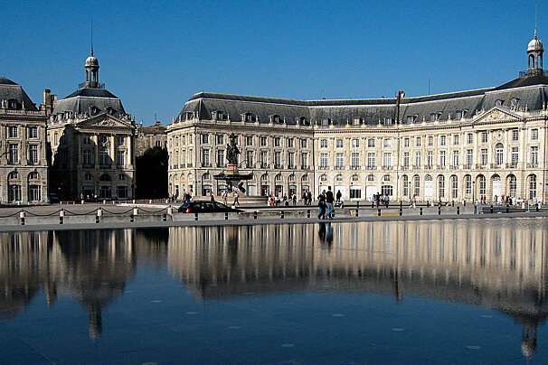 A large building with a fountain in front of it