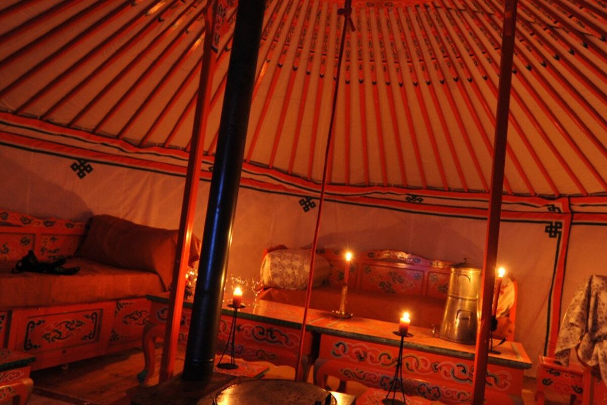 the interior of a yurt, candlelight