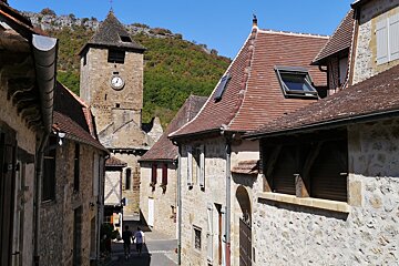 looking down a street to the church tower in autoire
