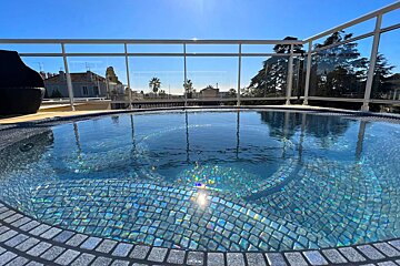 A large swimming pool with a view of a city