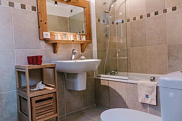 A bathroom with a sink a toilet and a bathtub