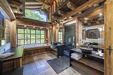 A bathroom with two sinks and a large window