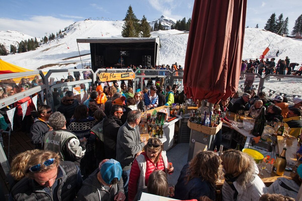 A crowd of people are gathered in front of a sign that says olly pie