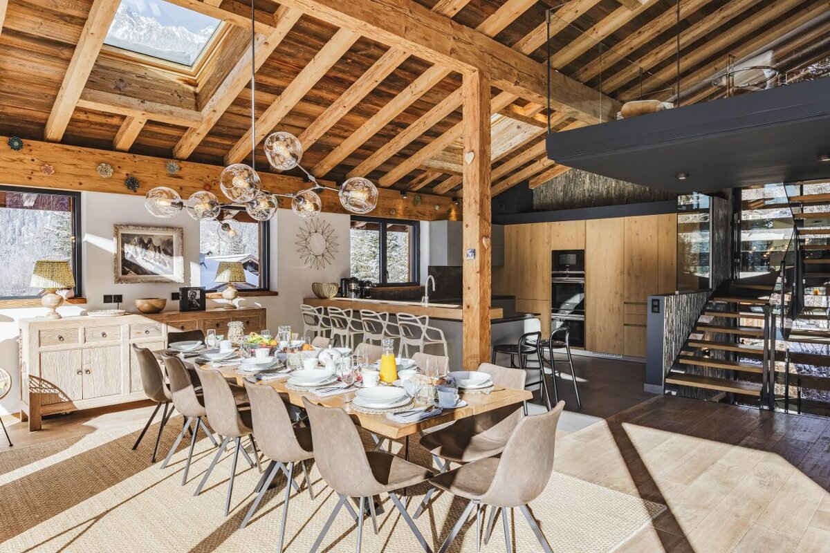 A dining room table with plates and glasses on it