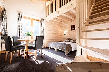 A bedroom with stairs leading up to the second floor