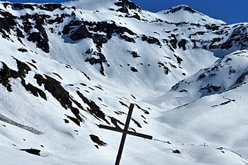 a cross on the mountain side