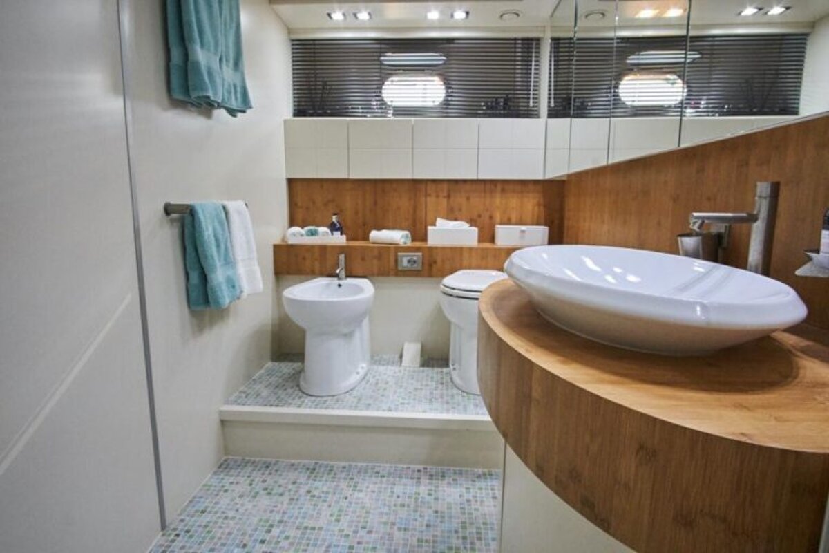 A bathroom with a sink toilet and bidet
