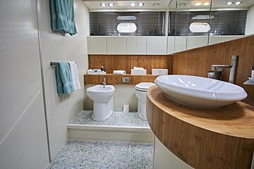 A bathroom with a sink toilet and bidet