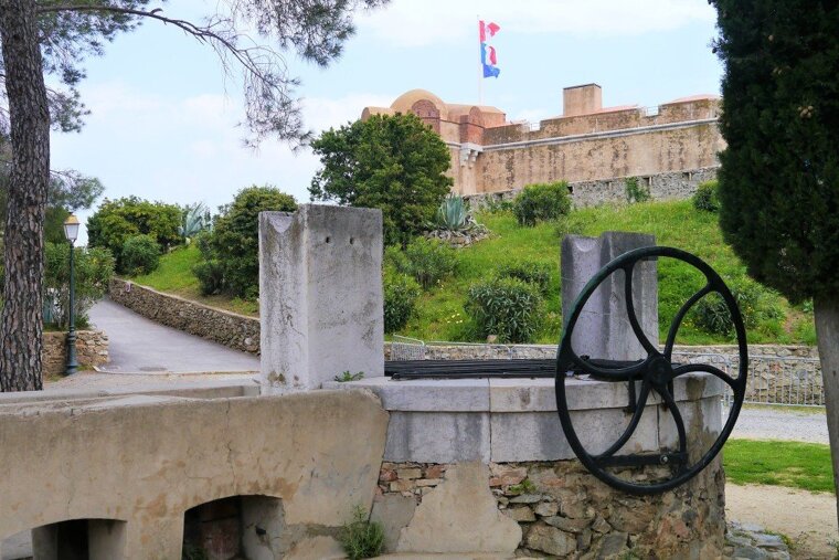 well in the st tropez citadelle, fort in background