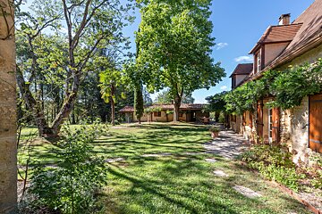 A large house with a large lawn in front of it