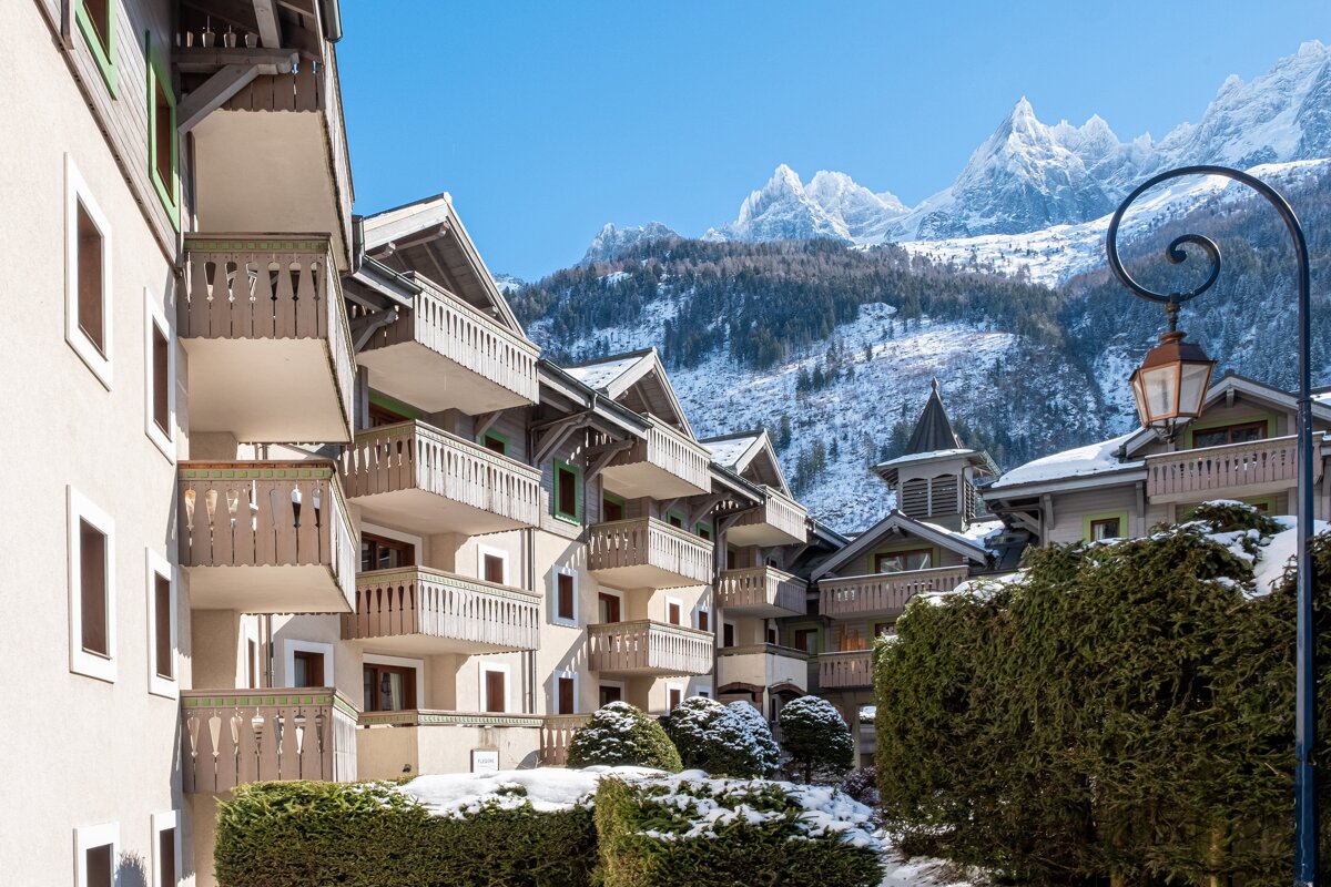 A building with balconies has a sign that says ' altitude ' on it