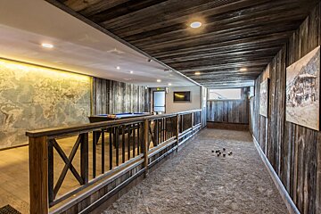 A long hallway with a pool table in the middle