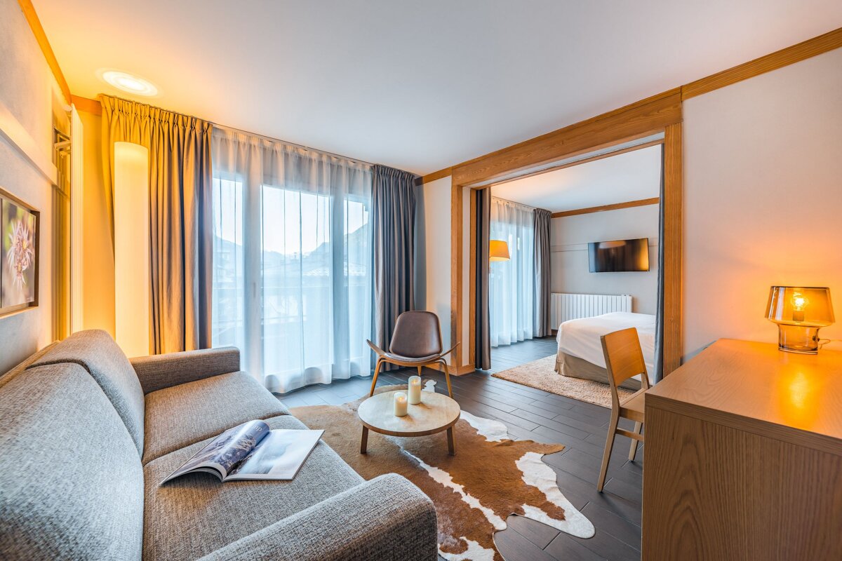 A living room with a couch a chair and a table