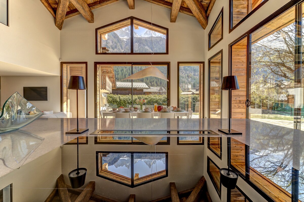 A room with a lot of windows and a table