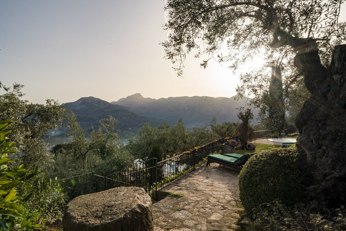 A stone walkway with a view of mountains in the background