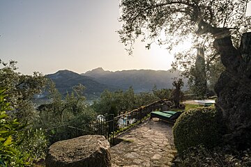 A stone walkway with a view of mountains in the background