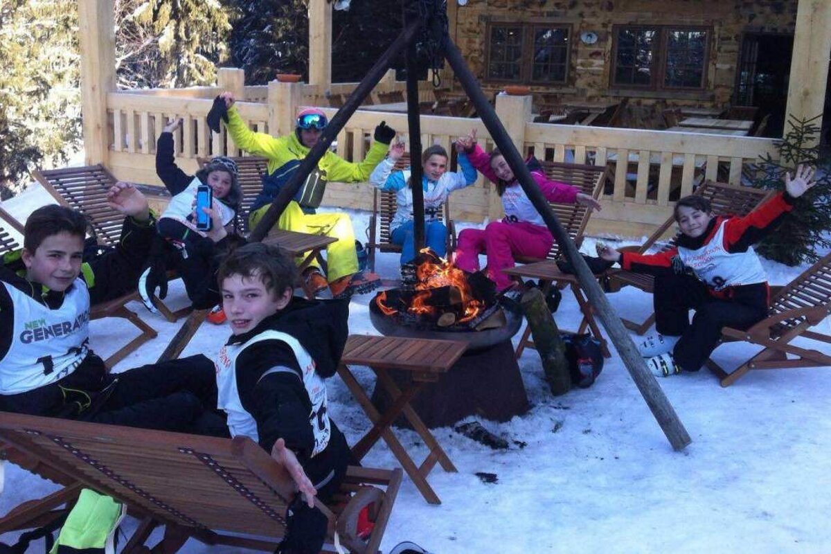 children around a fire in the snow