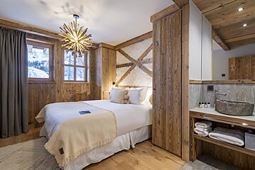 A bedroom with a large bed and a sink