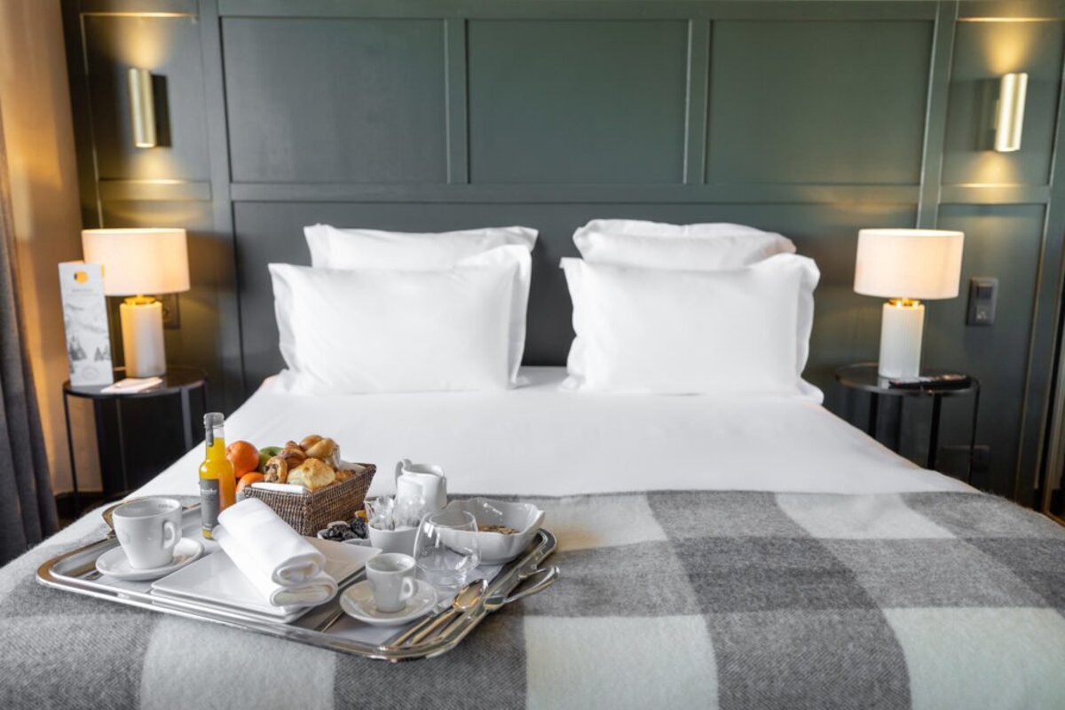 A bed with a tray of food on it