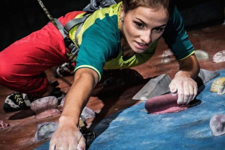 a woman on a climbing wall