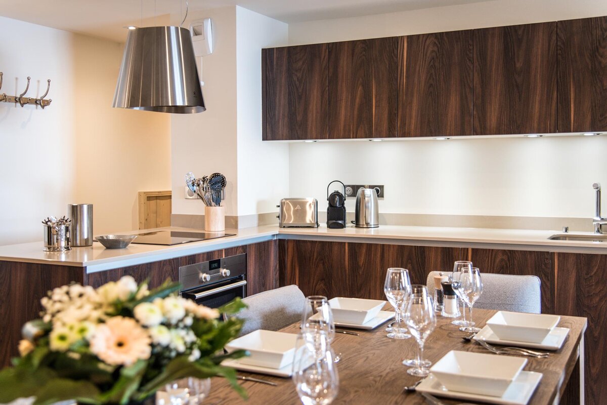 A kitchen with wooden cabinets and stainless steel appliances