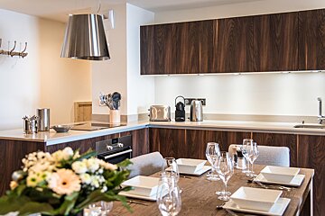A kitchen with wooden cabinets and stainless steel appliances