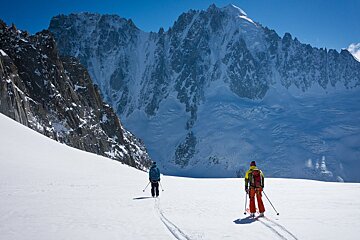 two skiers with a dramatic mountain view