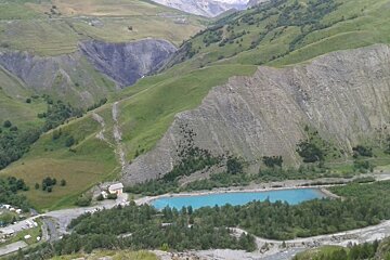 a bright blue lake seen from above