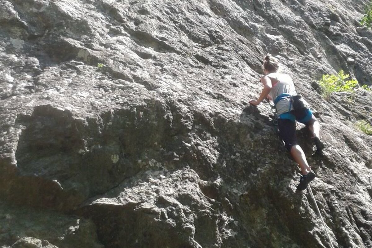 a woman climbing a route