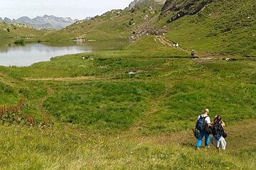 people walking towards a climbing route