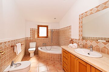 A bathroom with a toilet a sink and a bathtub