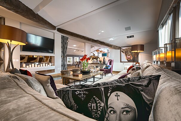 A living room with a couch and a pillow that says blessed