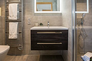 A bathroom with a sink and a towel rack